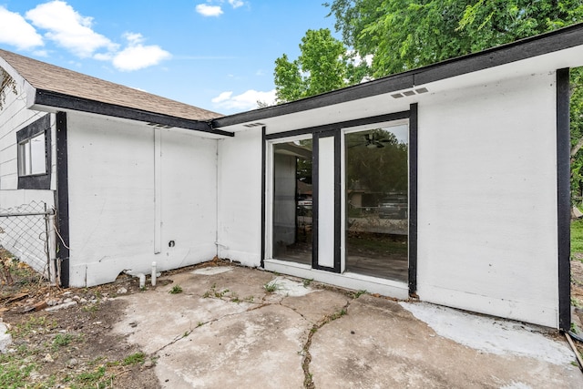 4726 Angleton St, Houston, TX 77033 - view of side of property featuring roof with shingles and a patio