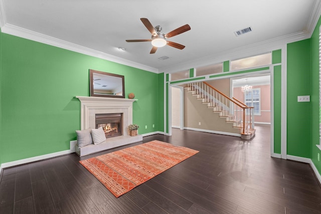 62 Treescape Cir, The Woodlands, TX 77381 - living area with ornamental molding, stairs, a glass covered fireplace, a ceiling fan, and a chandelier