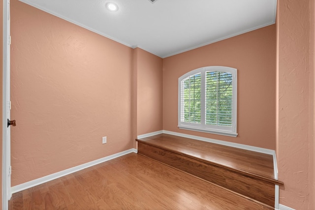 62 Treescape Cir, The Woodlands, TX 77381 - empty room with crown molding, wood finished floors, and baseboards