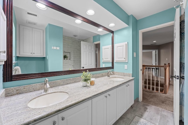 62 Treescape Cir, The Woodlands, TX 77381 - full bathroom with double vanity, recessed lighting, and tiled shower