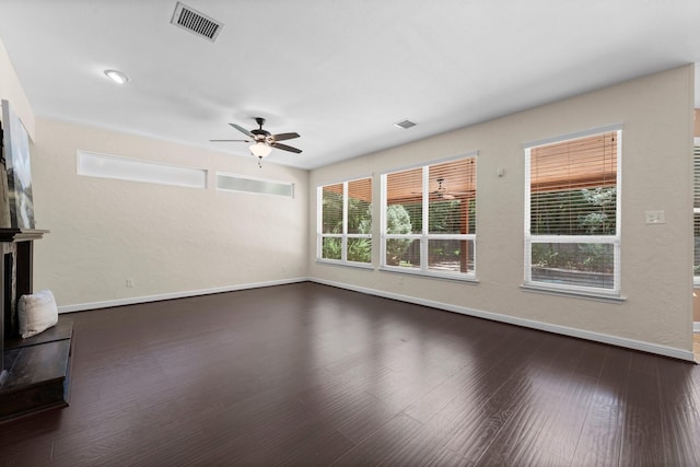 62 Treescape Cir, The Woodlands, TX 77381 - unfurnished living room featuring a ceiling fan, baseboards, and dark wood-style flooring
