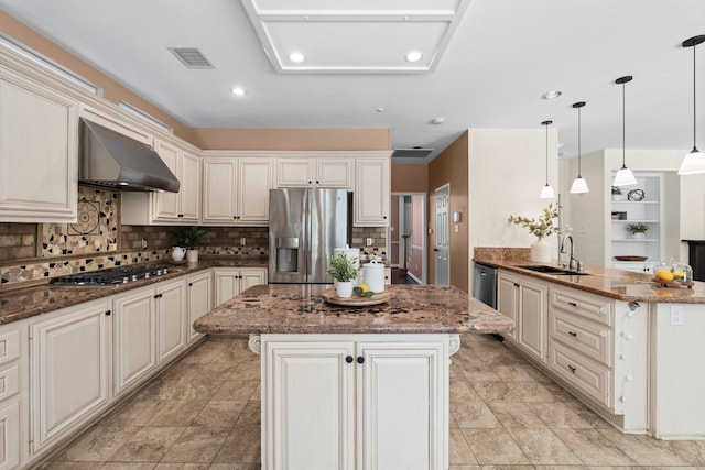 62 Treescape Cir, The Woodlands, TX 77381 - kitchen with appliances with stainless steel finishes, wall chimney exhaust hood, a sink, a kitchen island, and decorative backsplash