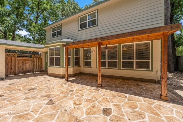 62 Treescape Cir, The Woodlands, TX 77381 - rear view of house featuring a gate and a patio