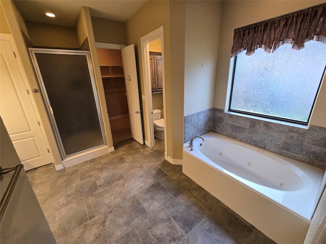 1008 Heritage Oaks Dr, Angleton, TX 77515 - full bathroom featuring toilet, a stall shower, a jetted tub, baseboards, and a walk in closet