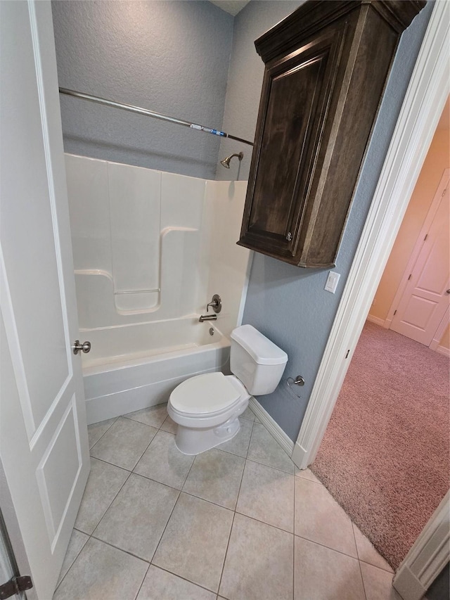 1008 Heritage Oaks Dr, Angleton, TX 77515 - full bath with toilet,  shower combination, baseboards, tile patterned floors, and a textured wall