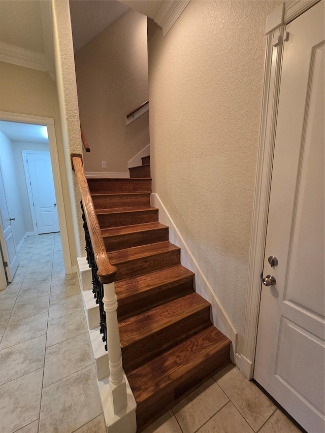 1008 Heritage Oaks Dr, Angleton, TX 77515 - staircase with tile patterned flooring, a textured wall, crown molding, and baseboards