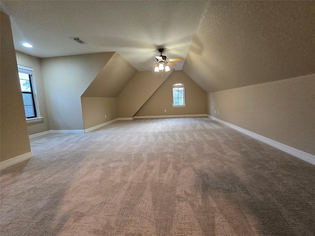 1008 Heritage Oaks Dr, Angleton, TX 77515 - additional living space featuring carpet, a textured ceiling, a ceiling fan, lofted ceiling, and baseboards