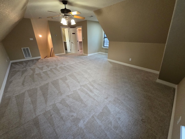 1008 Heritage Oaks Dr, Angleton, TX 77515 - additional living space with light carpet, lofted ceiling, ceiling fan, a textured ceiling, and baseboards