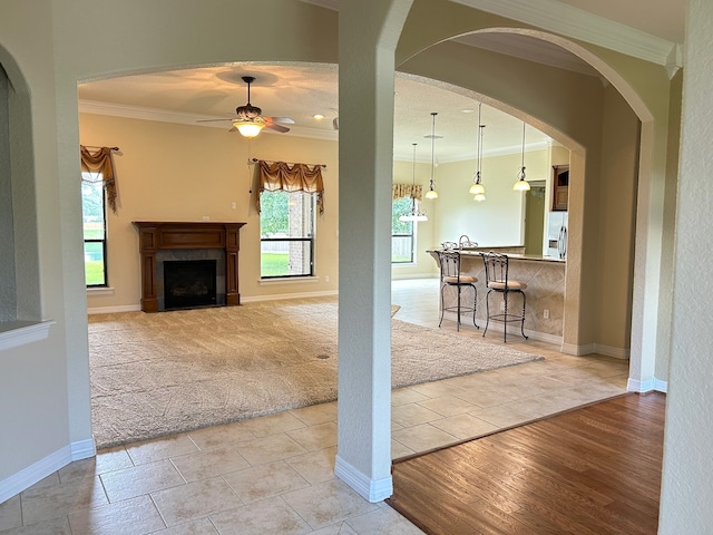 1008 Heritage Oaks Dr, Angleton, TX 77515 - living area with crown molding, a ceiling fan, light tile patterned floors, baseboards, and a fireplace