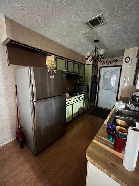 5363 Marian St, Katy, TX 77493 - kitchen featuring freestanding refrigerator, a chandelier, dark wood-style floors, a sink, and green cabinets