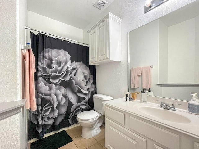17218 Marquette Point Ln, Humble, TX 77346 - bathroom with tile patterned floors, toilet, a textured wall, vanity, and a shower with shower curtain