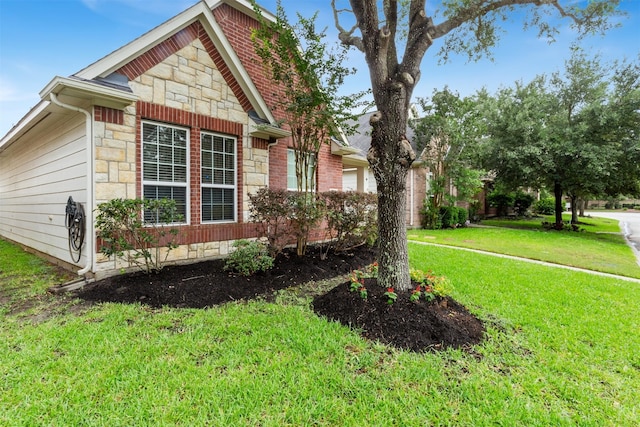 17218 Marquette Point Ln, Humble, TX 77346 - view of side of property featuring stone siding and a lawn
