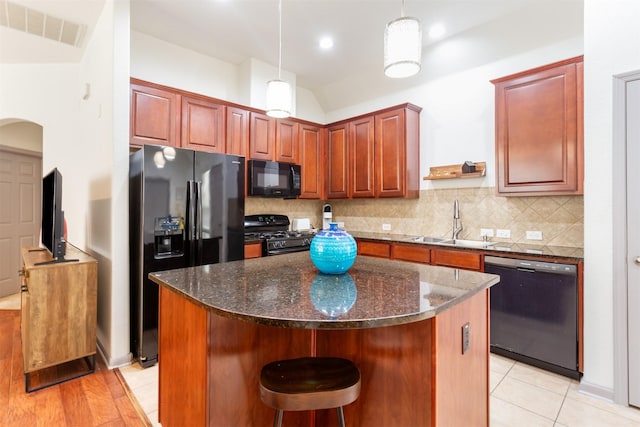 17218 Marquette Point Ln, Humble, TX 77346 - kitchen featuring black appliances, a sink, tasteful backsplash, a center island, and hanging light fixtures