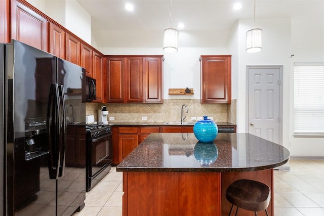 17218 Marquette Point Ln, Humble, TX 77346 - kitchen featuring black appliances, a kitchen island, decorative backsplash, a sink, and light tile patterned flooring