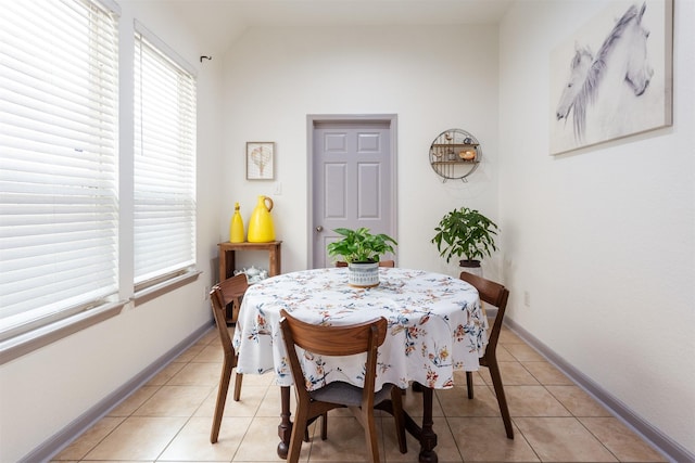 17218 Marquette Point Ln, Humble, TX 77346 - dining room featuring light tile patterned floors, lofted ceiling, and baseboards