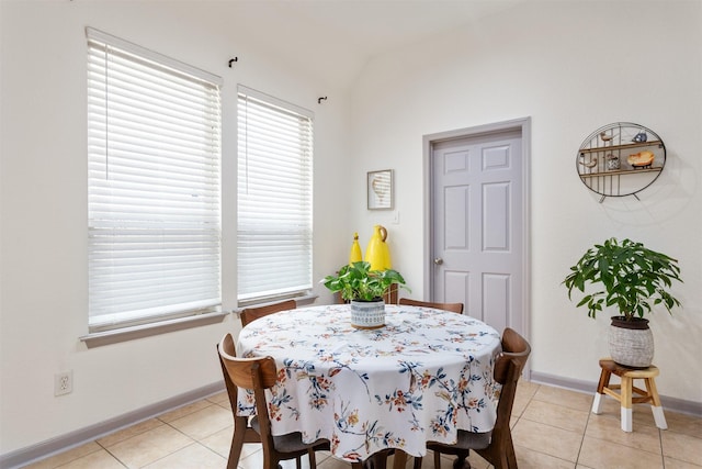 17218 Marquette Point Ln, Humble, TX 77346 - dining space with light tile patterned floors, lofted ceiling, and baseboards