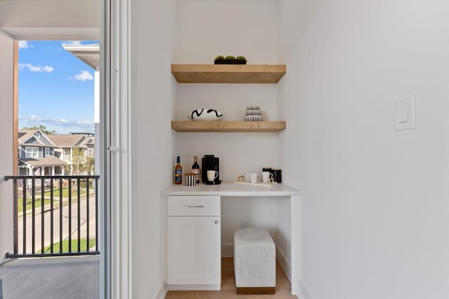 432 W 24th St, Houston, TX 77008 - bar area featuring baseboards and light wood finished floors