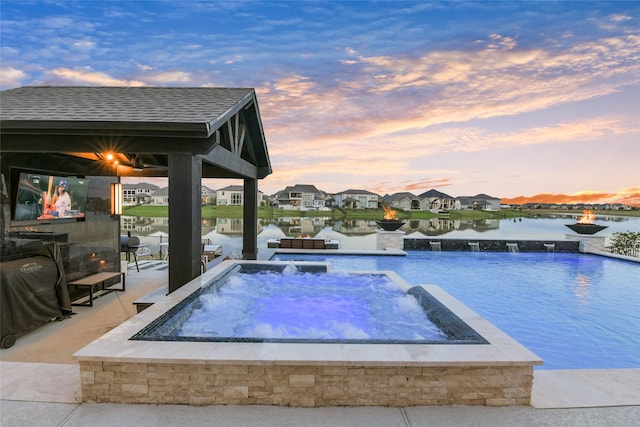 18115 Bachman Branch Dr, Cypress, TX 77433 - view of swimming pool with a pool with connected hot tub, a residential view, and a water view