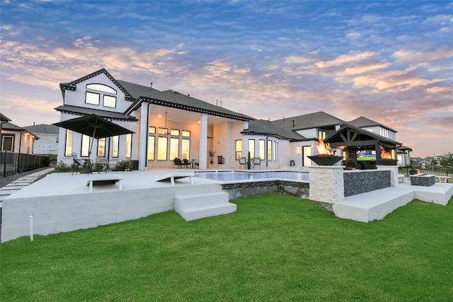 18115 Bachman Branch Dr, Cypress, TX 77433 - back of property at dusk featuring a patio