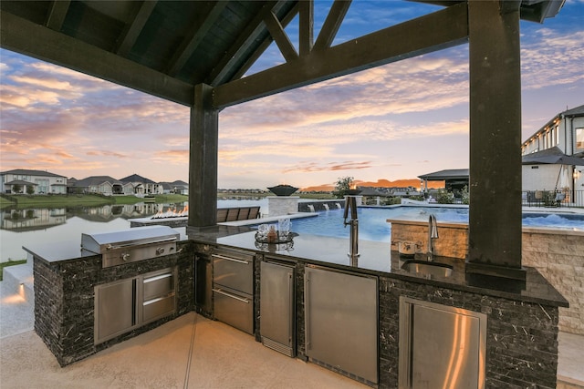 18115 Bachman Branch Dr, Cypress, TX 77433 - patio terrace at dusk featuring a sink, a water view, and a residential view