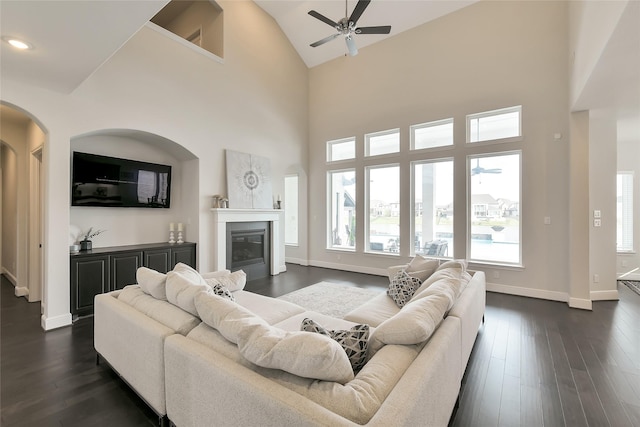18115 Bachman Branch Dr, Cypress, TX 77433 - living area with ceiling fan, plenty of natural light, a glass covered fireplace, baseboards, and high vaulted ceiling