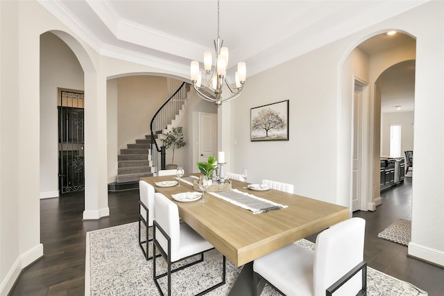18115 Bachman Branch Dr, Cypress, TX 77433 - dining room featuring stairway, arched walkways, a chandelier, dark wood-style floors, and baseboards