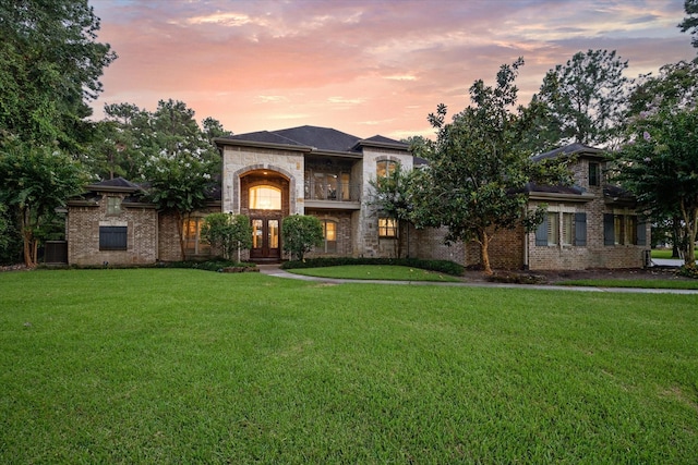 10250 Clubhouse Cir, Magnolia, TX 77354 - french provincial home with french doors, a lawn, brick siding, a balcony, and cooling unit