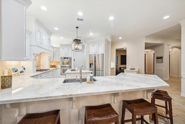 10250 Clubhouse Cir, Magnolia, TX 77354 - kitchen featuring stainless steel appliances, a sink, a peninsula, light stone counters, and recessed lighting