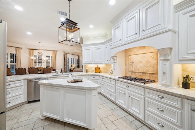 10250 Clubhouse Cir, Magnolia, TX 77354 - kitchen featuring stainless steel appliances, a chandelier, white cabinetry, decorative backsplash, and a peninsula