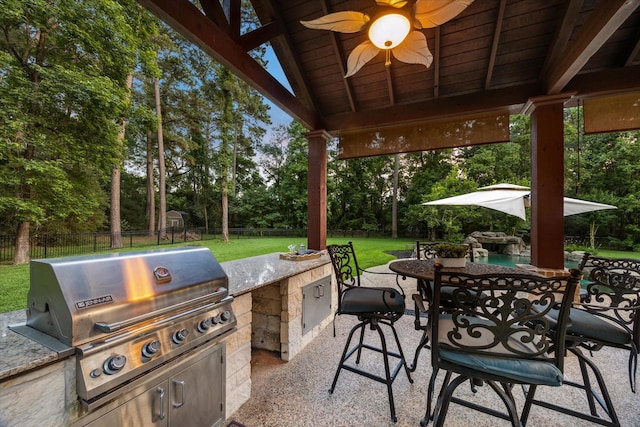 10250 Clubhouse Cir, Magnolia, TX 77354 - view of patio featuring view of scattered trees, outdoor dining area, and a ceiling fan