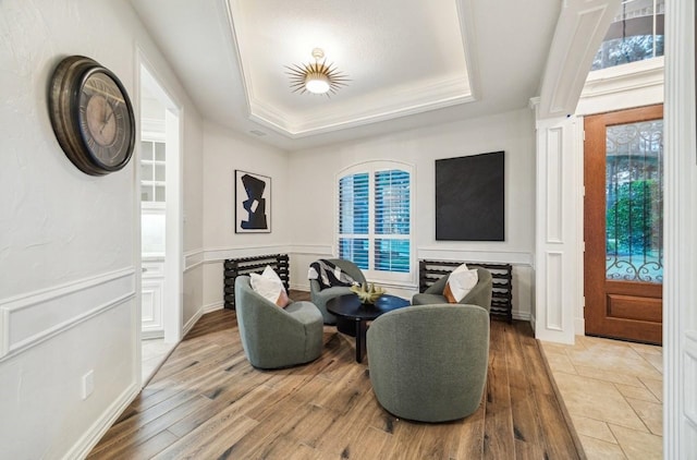 10250 Clubhouse Cir, Magnolia, TX 77354 - living area with a tray ceiling, light wood-type flooring, plenty of natural light, and crown molding
