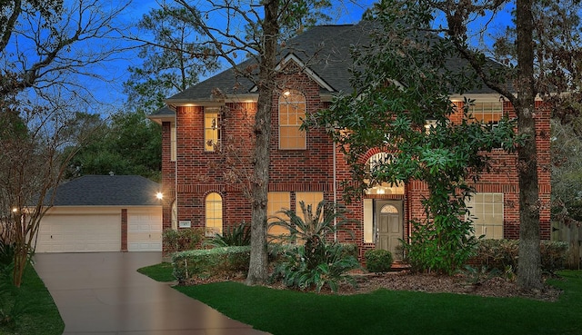 43 Danville Crossing Ct, The Woodlands, TX 77385 - view of front of home with brick siding, a shingled roof, driveway, and a detached garage