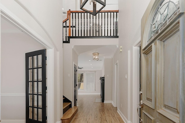 43 Danville Crossing Ct, The Woodlands, TX 77385 - entrance foyer featuring a high ceiling, light wood-style flooring, baseboards, ornamental molding, and stairs