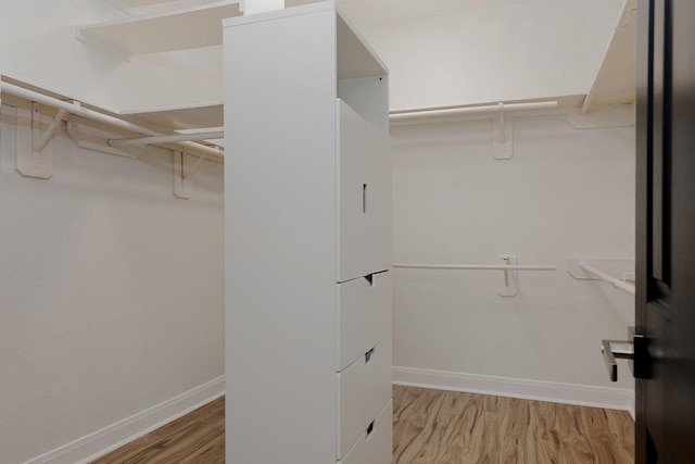 43 Danville Crossing Ct, The Woodlands, TX 77385 - walk in closet featuring wood finished floors