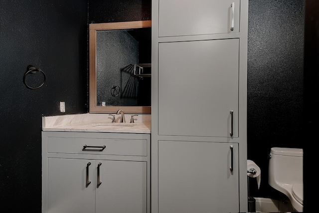 43 Danville Crossing Ct, The Woodlands, TX 77385 - bathroom featuring toilet, vanity, and a textured wall