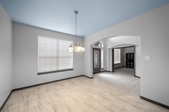 13909 Stonewood Ct, Rosharon, TX 77583 - unfurnished room featuring arched walkways, a chandelier, and baseboards