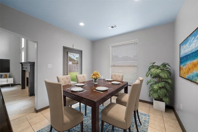 13909 Stonewood Ct, Rosharon, TX 77583 - dining space featuring light tile patterned floors, baseboards, recessed lighting, and a fireplace