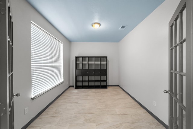 13909 Stonewood Ct, Rosharon, TX 77583 - spare room featuring plenty of natural light, light marble finish flooring, and baseboards