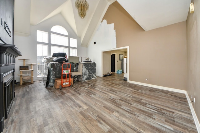 23214 Gatecreek Ct, Katy, TX 77494 - living room featuring wood finished floors, high vaulted ceiling, and baseboards
