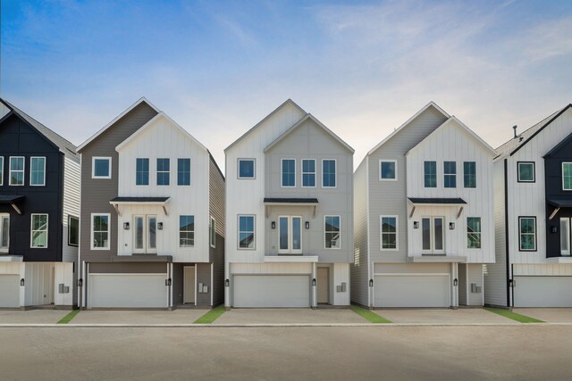 5835 Highland Sun Ln, Houston, TX 77091 - townhome / multi-family property with a garage and board and batten siding