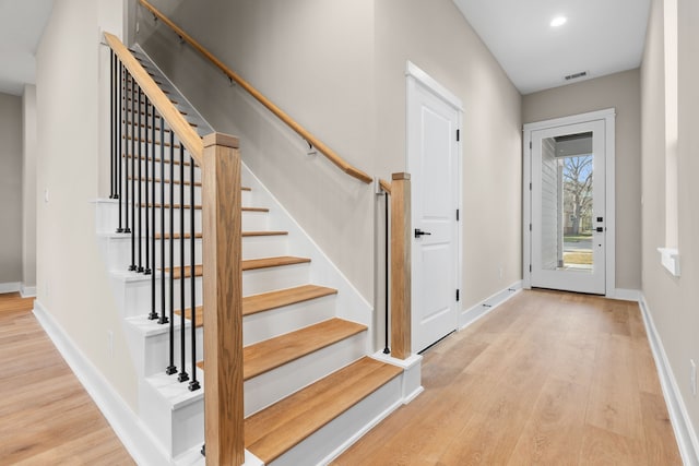 5833 Highland Sun Ln, Houston, TX 77091 - entryway featuring stairs, wood finished floors, baseboards, and recessed lighting