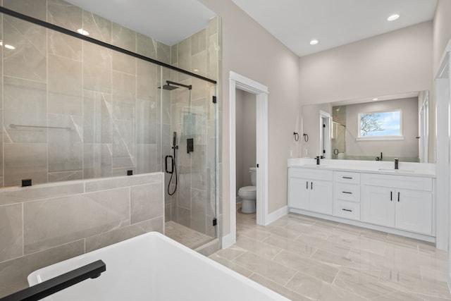 5833 Highland Sun Ln, Houston, TX 77091 - full bath with a stall shower, a soaking tub, toilet, double vanity, and baseboards