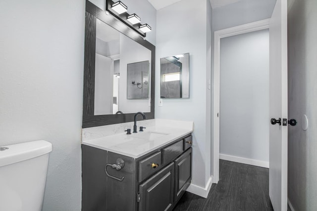 10603 Zircon Ct, Houston, TX 77099 - bathroom with wood finished floors, vanity, toilet, and baseboards