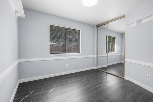 10603 Zircon Ct, Houston, TX 77099 - unfurnished bedroom featuring wood finished floors, a closet, and baseboards