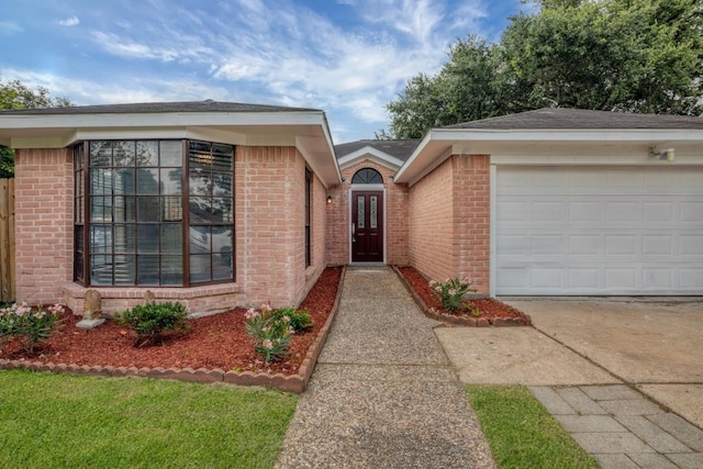 10603 Zircon Ct, Houston, TX 77099 - ranch-style home with concrete driveway, brick siding, and an attached garage