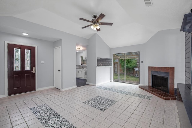 10603 Zircon Ct, Houston, TX 77099 - foyer entrance with vaulted ceiling, a brick fireplace, light tile patterned floors, baseboards, and ceiling fan