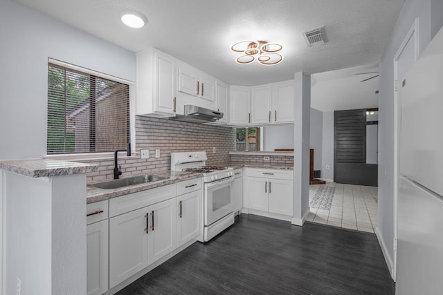 10603 Zircon Ct, Houston, TX 77099 - kitchen featuring white appliances, a sink, white cabinets, dark wood finished floors, and backsplash