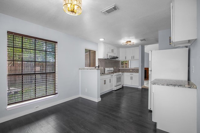10603 Zircon Ct, Houston, TX 77099 - kitchen with white gas range, dark wood-style floors, a chandelier, white cabinetry, and a textured ceiling