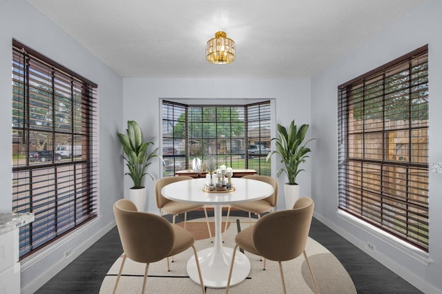 10603 Zircon Ct, Houston, TX 77099 - dining room featuring a chandelier, dark wood-style flooring, and baseboards