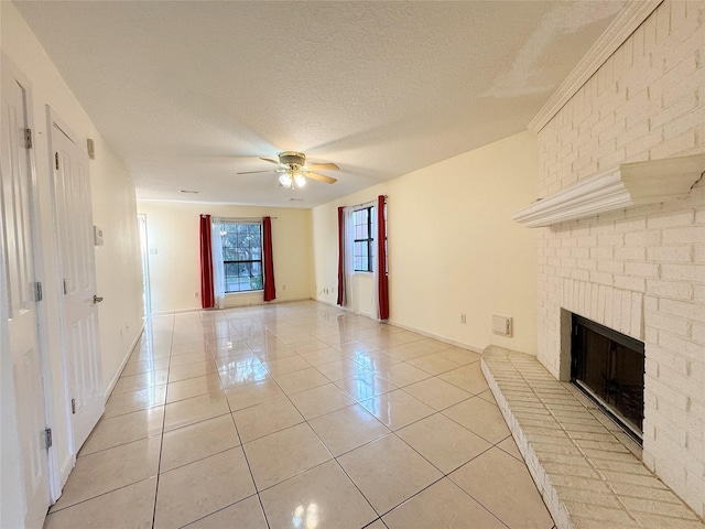 8631 Mapletwist St, Houston, TX 77083 - unfurnished living room featuring light tile patterned flooring, a ceiling fan, a fireplace, a textured ceiling, and baseboards